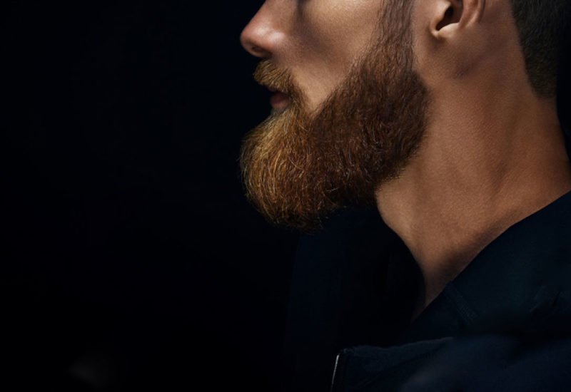stock-photo-single-standing-in-profile-young-handsome-serious-bearded-man-in-dark-hoodie-beard-photo-close-up-1536129041